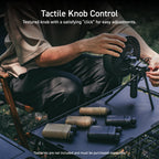 image of a black nestout portable outdoor fan on an outdoor camping table with beige and black NESTOUT power banks in all sizes | overlay text reads: tactile knob control: textured knob with a satisfying "click" for easy adjustments. | disclaimer: batteries are not included and must be purchased separately 